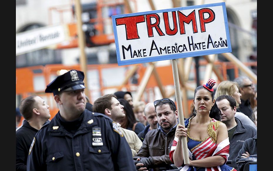 People take part in an anti-Donald Trump, pro-immigration protest outside the Plaza Hotel, where US 