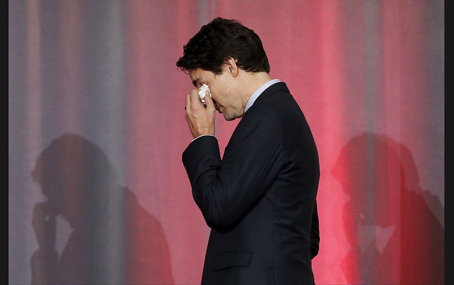 Canada’s Prime Minister Justin Trudeau wipes his eyes after speaking during the release of the