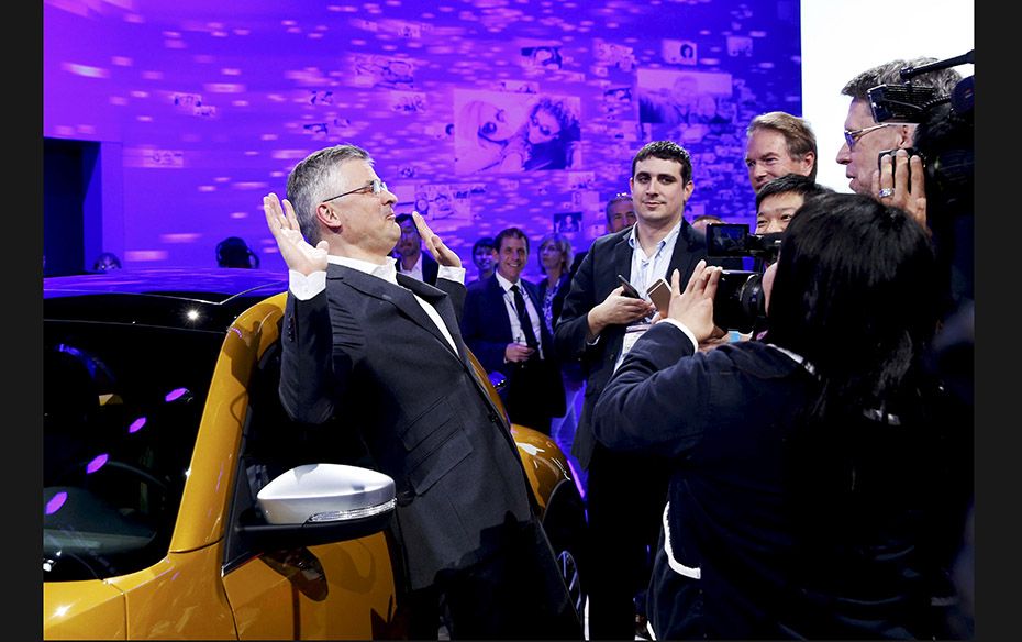 Michael Horn, President and CEO of Volkswagen America, reacts when he was mobbed by media persons af