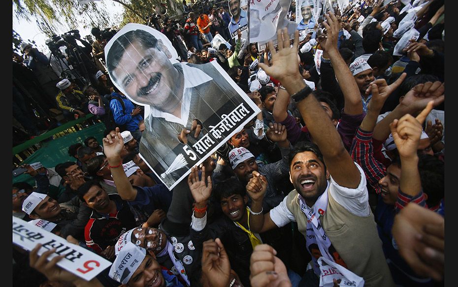 Supporters of Aam Aadmi Party (AAP) hold portraits of AAP chief and its chief ministerial candidate 