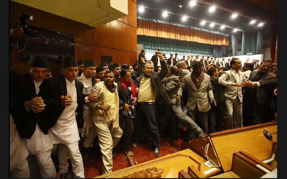 Constitution assembly members shout slogans in parliament during a meeting on the final day to draft