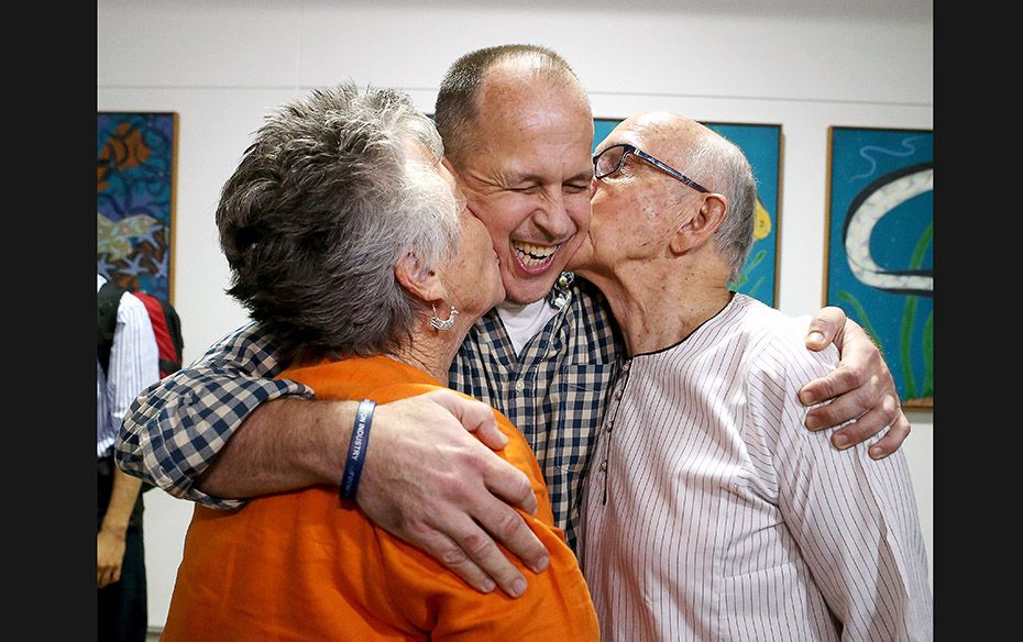 Australian journalist Peter Greste receives a kiss from his mother Lois and father Juris upon his re