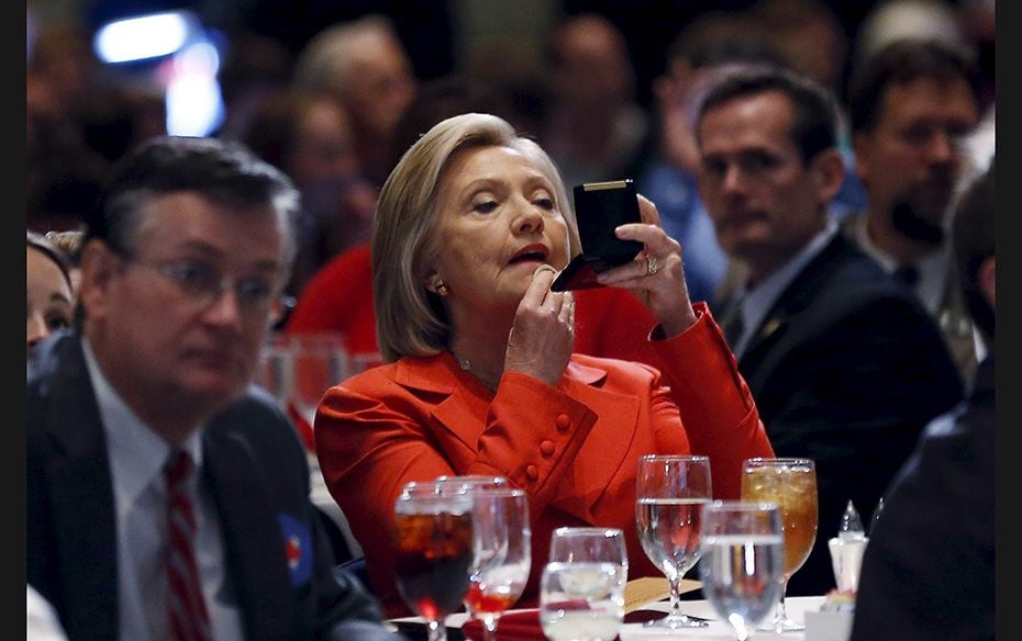 US Democratic presidential candidate Hillary Clinton does her make-up before speaking at the Iowa De