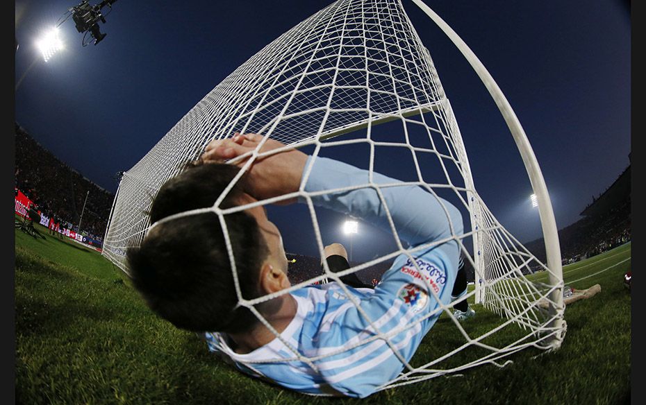 Argentina's Lionel Messi falls in the net during the Copa America 2015 final against Chile at th