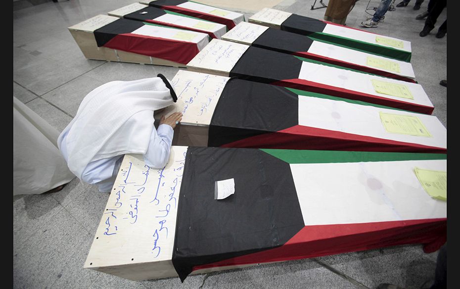 A man mourns the loss of victims in the Imam Sadeq mosque bombing in Kuwait City on June 27. The att