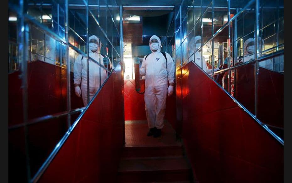 A worker in full protective gear disinfects the interior of a karaoke establishment in Seoul, South 