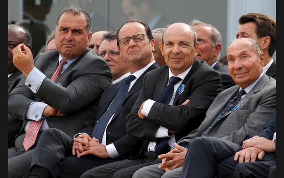 French President Francois Hollande looks at a flying display with Airbus Group Chief Strategy and Ma