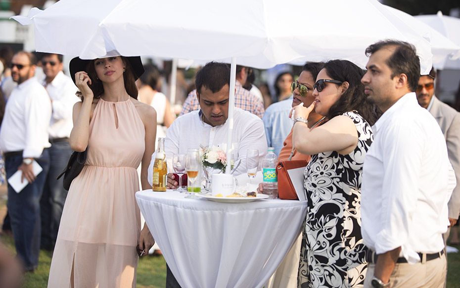 Patrons cooled off under umbrellas as they watched the action unfold                                