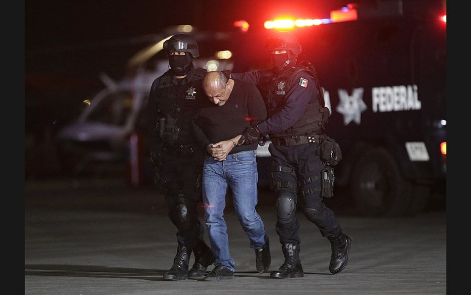 Servando ‘La Tuta’ Gomez is escorted by police officers during a press conference about 