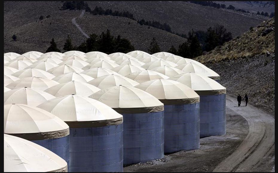 People walk by the High Altitude Cherenkov Experiment (HAWC) observatory during its inauguration on 