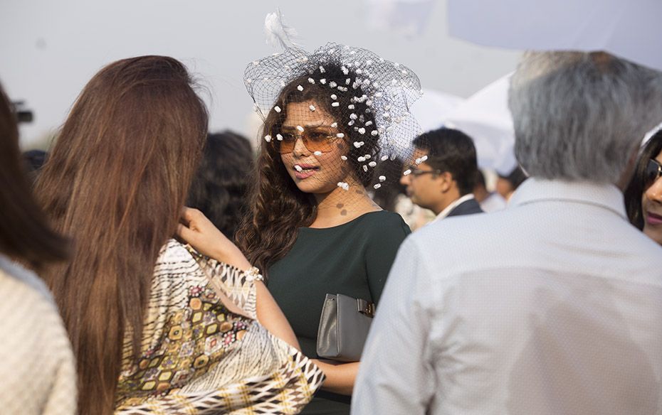 Socialites flaunt their fashionable headgear at the event.