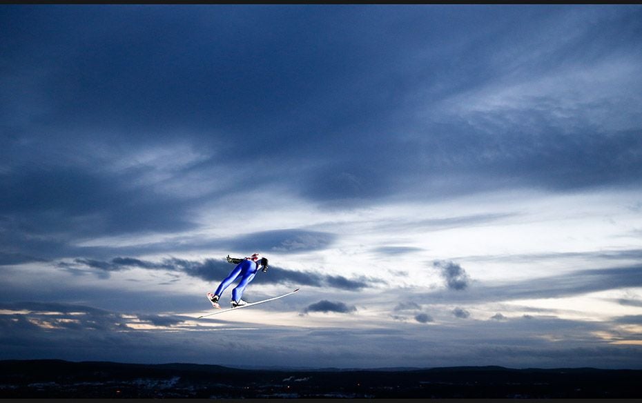 Michael Neumayer of Germany soars through the air during his jump in the men's large hill team s