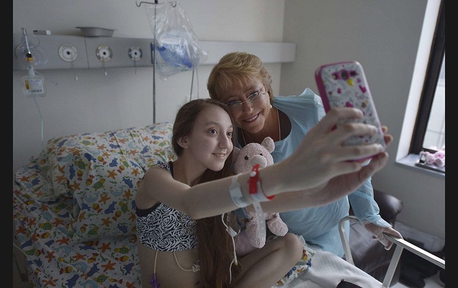 Chile's President Michelle Bachelet (right) poses for a selfie with Valentina Maureira, a 14-yea