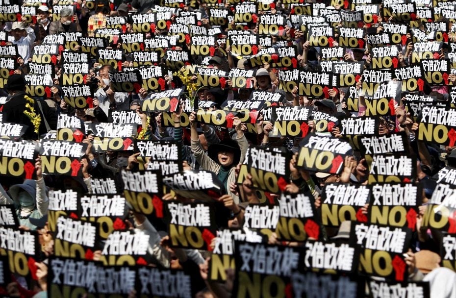 Protesters in Tokyo shout slogans against Japan's Prime Minister Shinzo Abe's administration