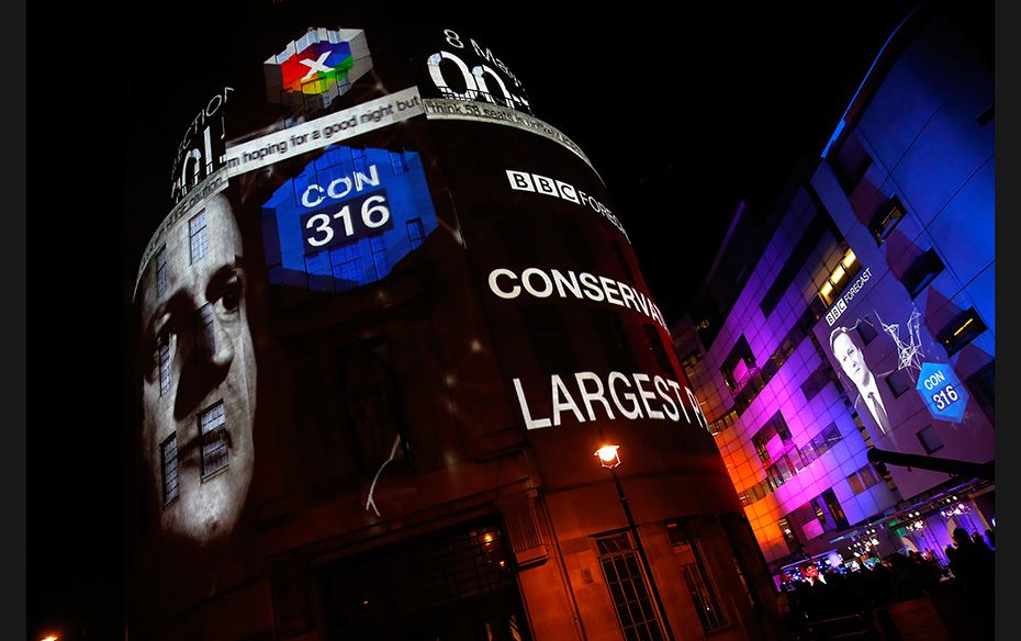 Exit polls results are projected on the side of the BBC headquarters after voting closed in Britain&