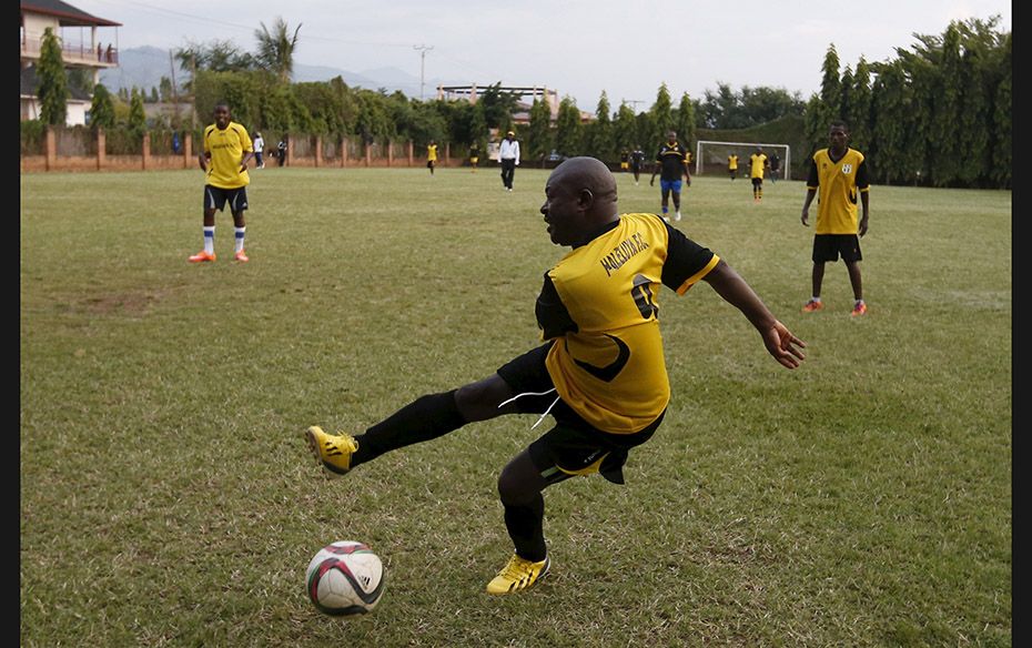 Burundi's President Pierre Nkurunziza kicks the ball during a soccer game with his friends in Bu