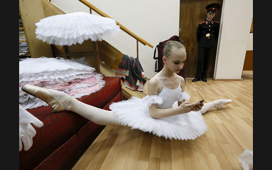 A student of the Krasnoyarsk choreographic college prepares backstage before a dress rehearsal of a 