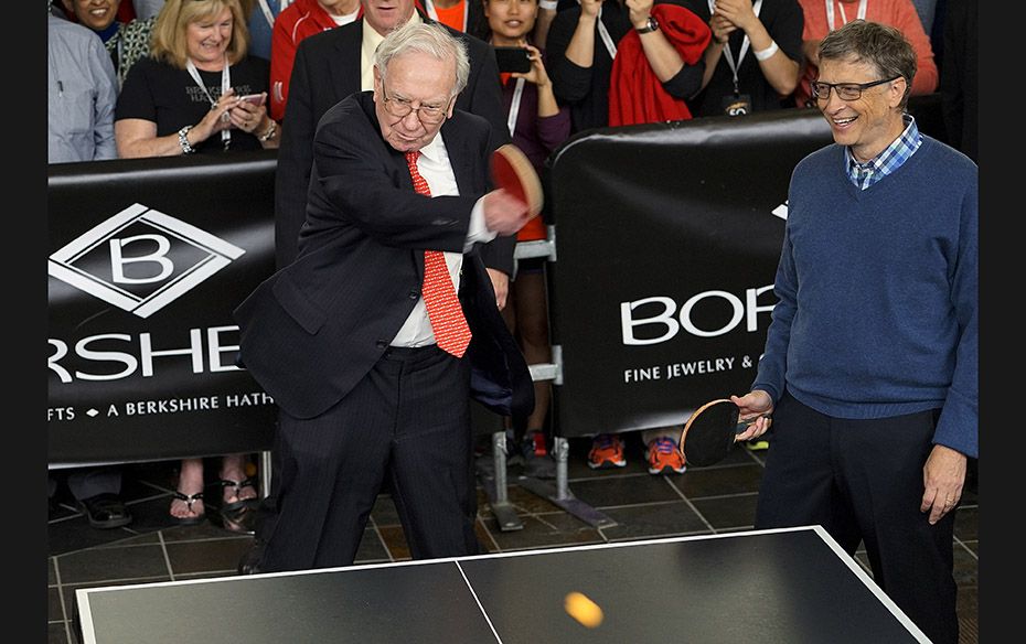 Berkshire Hathaway CEO Warren Buffett (left) plays table tennis with Microsoft co-founder Bill Gates