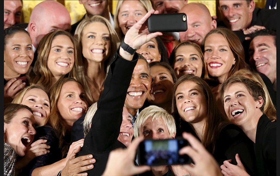 US President Barack Obama poses for a selfie taken by veteran star player Abby Wambach as he welcome