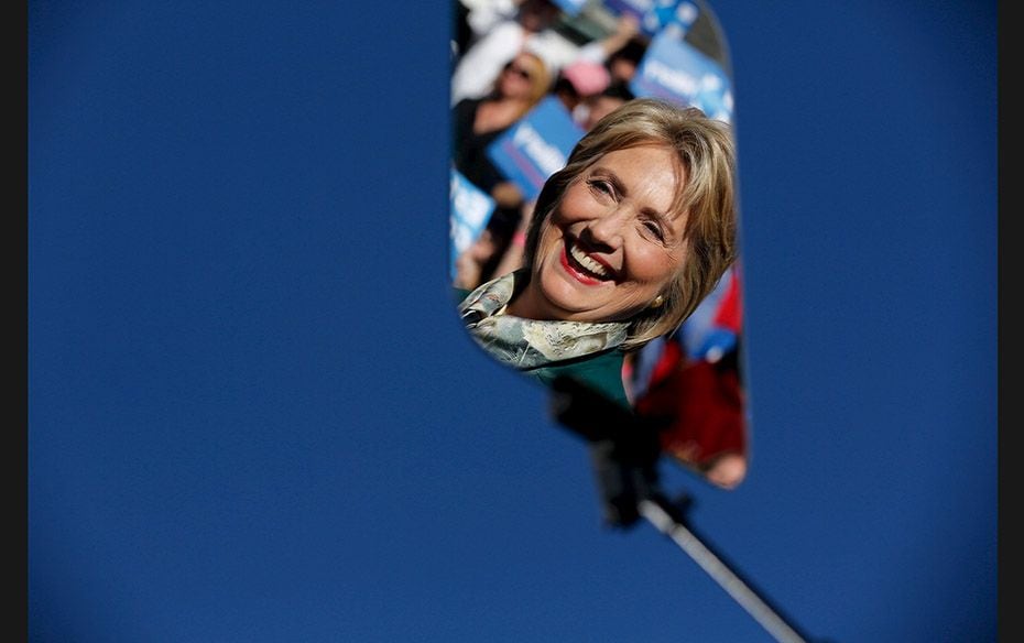 Democratic presidential candidate Hillary Clinton is reflected in a glass teleprompter as she holds 