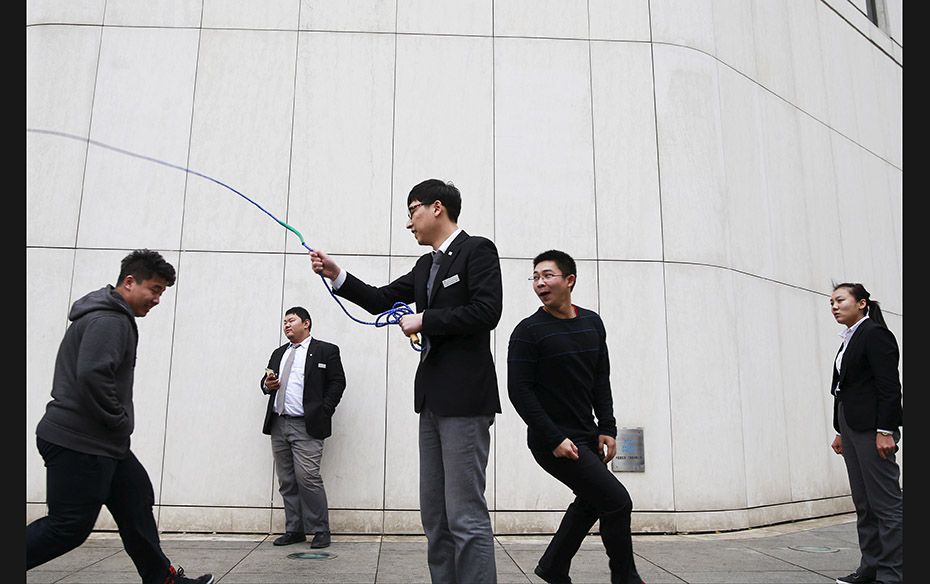 People jump rope during a lunch break in a financial district in Beijing, China, on November 12     