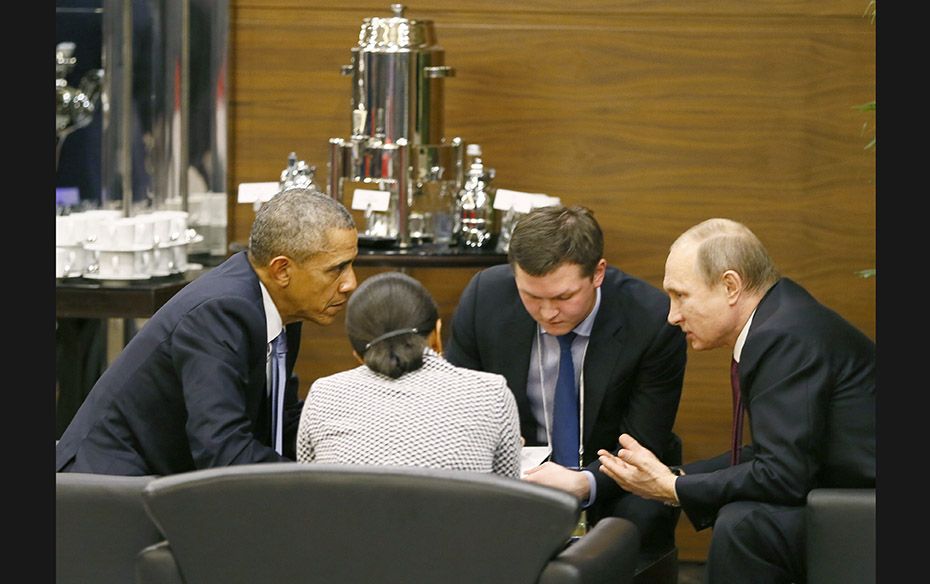 US President Barack Obama (left) with Russian President Vladimir Putin (right) and US security advis