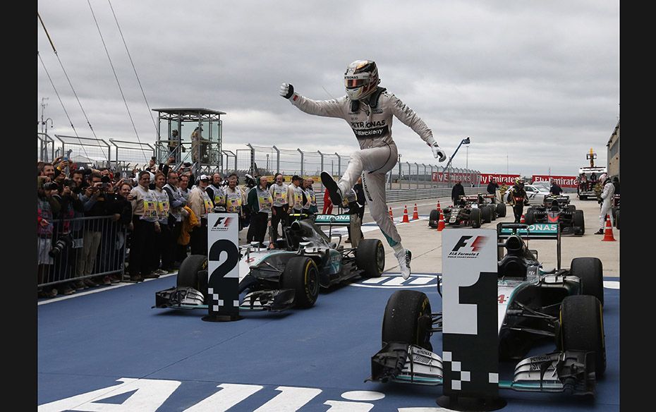 Mercedes Formula One driver Lewis Hamilton leaps out of his car after winning the US F1 Grand Prix a