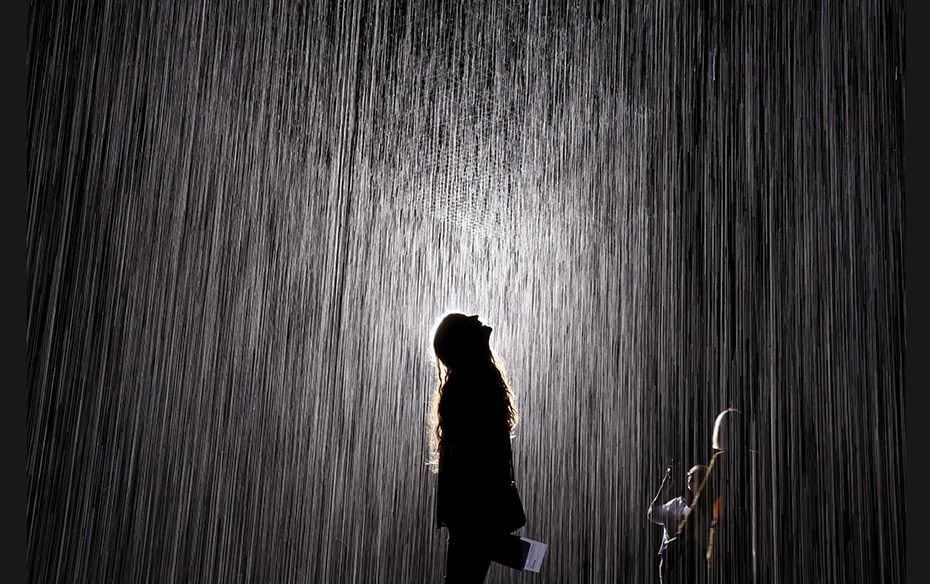 People walk through the Rain Room at the Los Angeles County Museum of Art in California on October 3