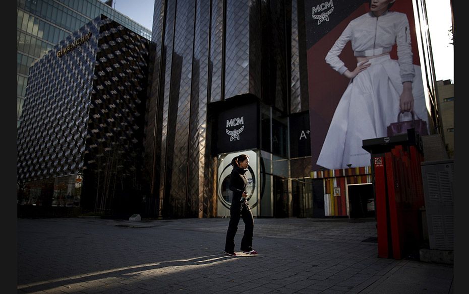 A woman walks on a street at Apgujeong luxury shopping district in Seoul, South Korea, on November 1