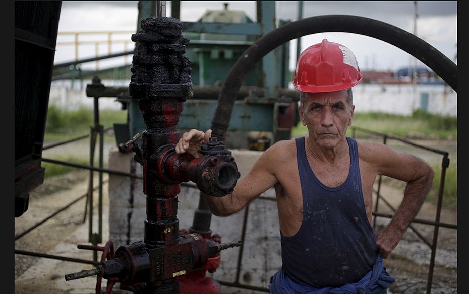 Alfredo, 69, a technician of Cuba's state-run oil company CUPET poses for a picture near an oil 