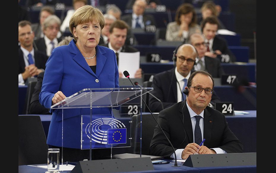 German Chancellor Angela Merkel (left) addresses the European Parliament as French President Francoi