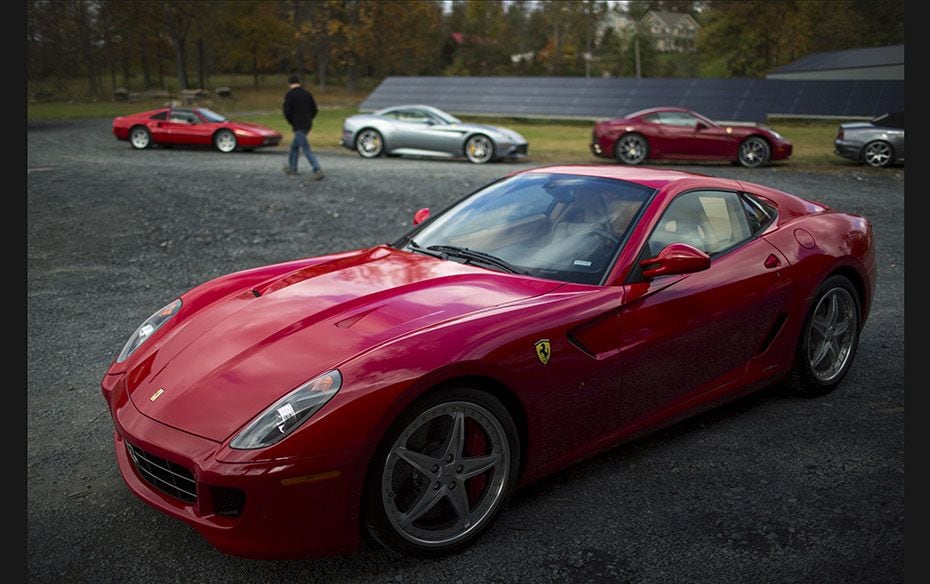 A man walks past Ferrari cars during an annual fall drive, organised by a Ferrari club, in Fishkill,