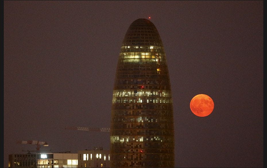 A view of the supermoon near Agbar tower after the lunar eclipse in Barcelona, Spain on September 28