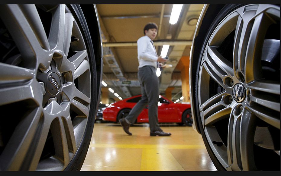 Logos of Volkswagen (right) and Audi are seen on the wheel of a car at a used-car dealership in Seou