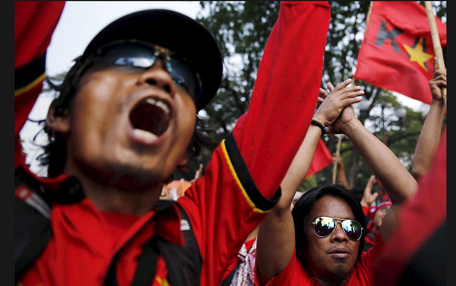 Indonesian workers shout slogans during a protest, against the government's decision to slash mi