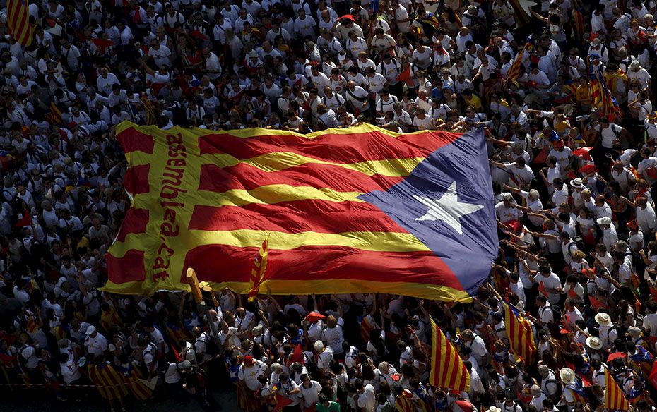 Catalan pro-independence supporters hold a giant "Estelada" (Catalan separatist flag) duri