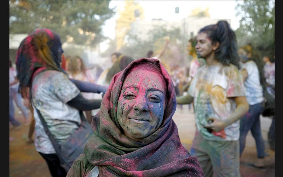 A Palestinian reveller takes part in a festival of colours in the West Bank city of Ramallah on Augu