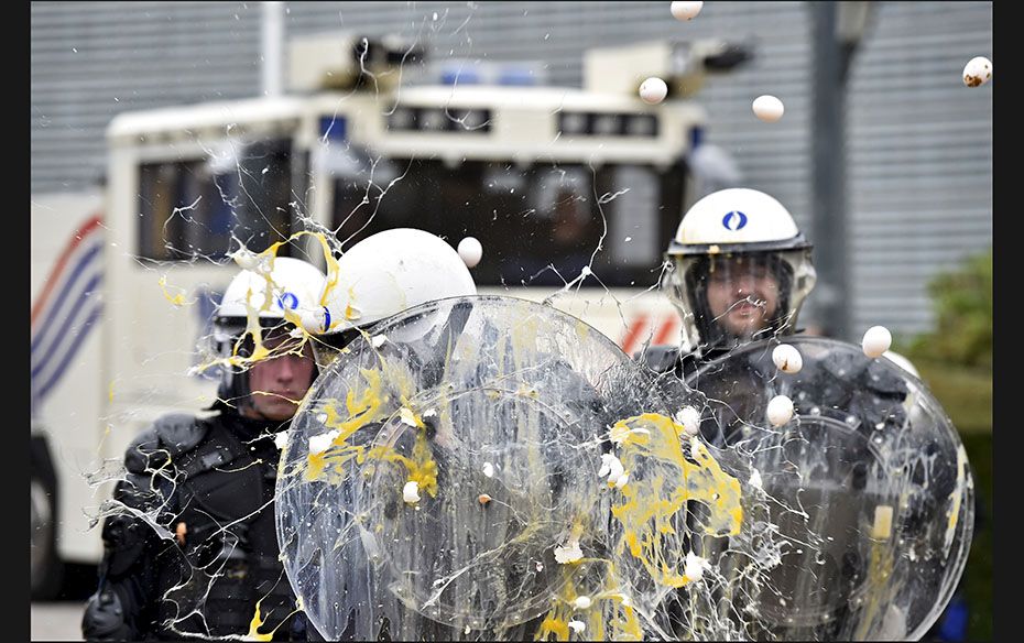 Policemen are hit by eggs as farmers and dairy farmers from all over Europe take part in a demonstra