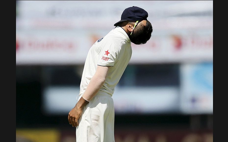 Indian captain Virat Kohli reacts after his teammate Lokesh Rahul misses a catch during the third da