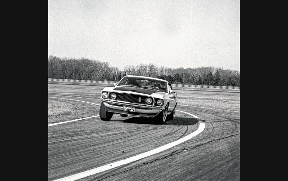 A 1969 Boss 302 being put through its paces on a race track                        