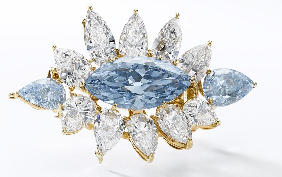  Set with a marquise-shaped fancy intense blue diamond weighing 6.64 carats, highlighted with t