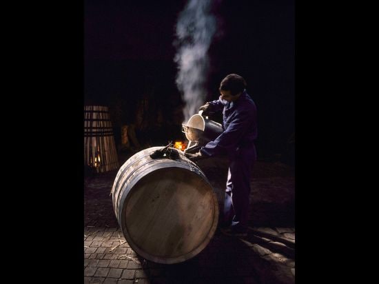 Name of photo: Cleaning Port BarrelDescription: Pouring boiling water into a Portuguese oak barrel t