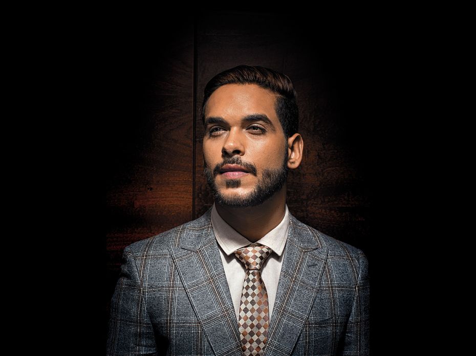 Aditya: Wide-peak lapel check jacket by Canali. Club-collar shirt by Bhane. Multi-tone tie by Alvaro