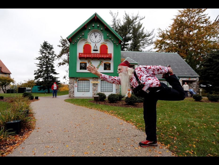 Santa Jerry Julian of Colorado Springs, Colorado shows some yoga moves outside the Santa House in Mi