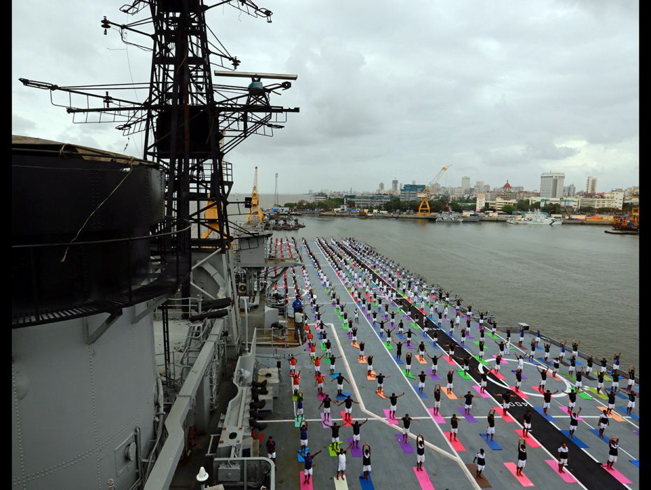 Members of Indian Navy perform yoga on the flight deck of INS Viraat, an Indian Navy's decommiss