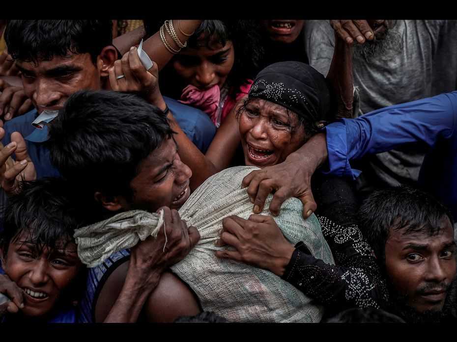 Rohingya refugees scramble for aid at a camp in Cox's Bazar, Bangladesh September 24, 2017. 