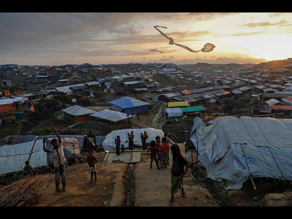 Rohingya refugee children fly improvised kites at the Kutupalong refugee camp near Cox's Bazar, 