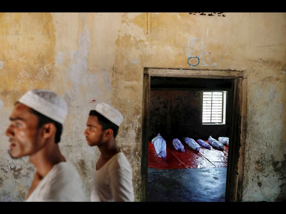 Bodies of Rohingya refugees, who died when their boat capsized while fleeing Myanmar, are placed in 