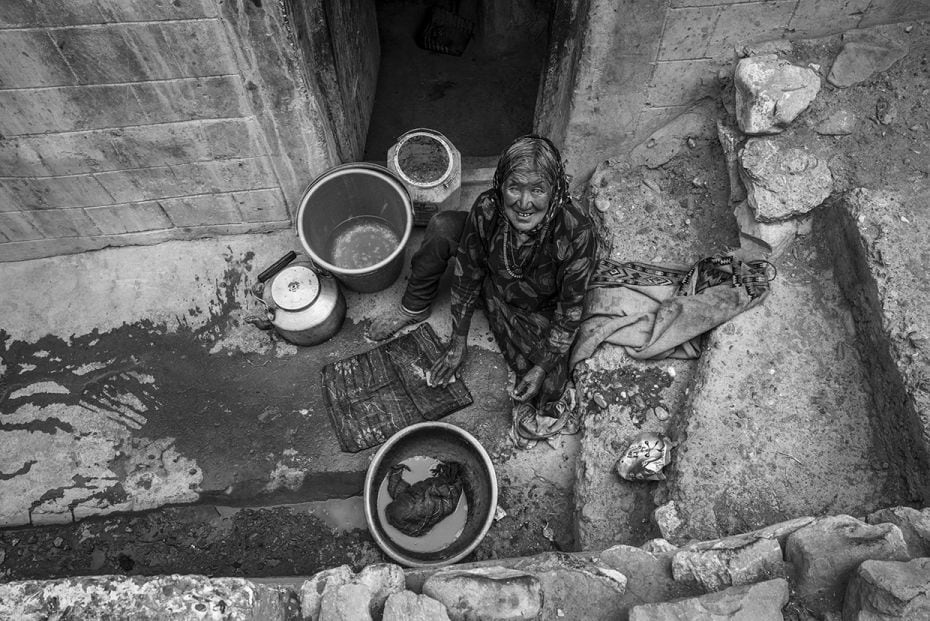 Matriarch of a family, washing clothes. Kibber, Himachal Pradesh                        