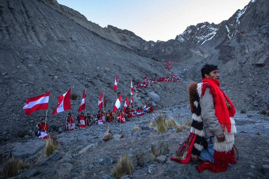 Pilgrims descend a rock face after a ceremony during the annual Qoyllurit'i (Snow and Star) fest